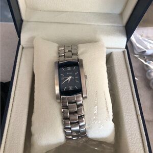 Bulova stainless steel women’s watch with navy blue face rectangle. With box